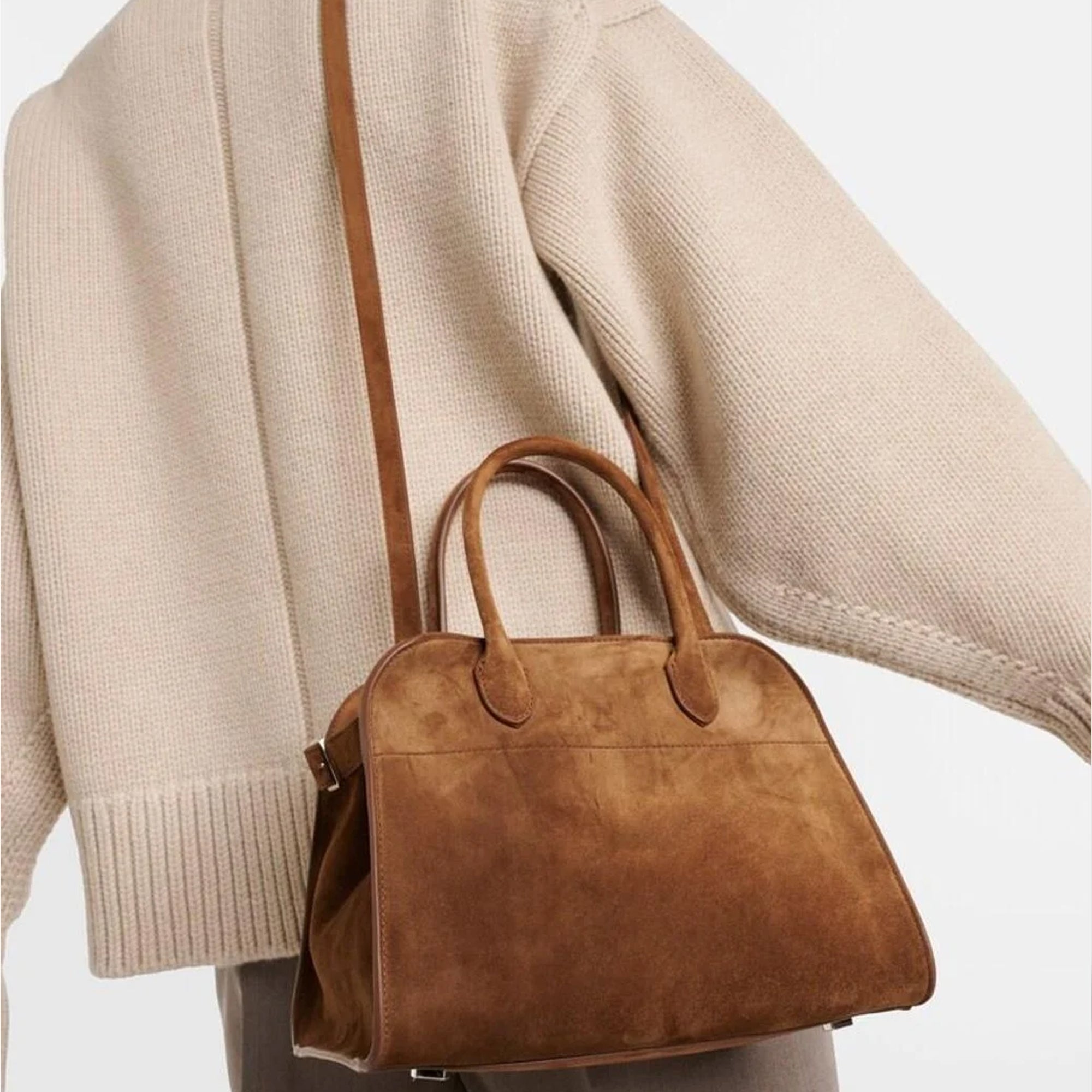 model with the Margaux 10 style suede tote bag in Coffee Brown with belted side details.