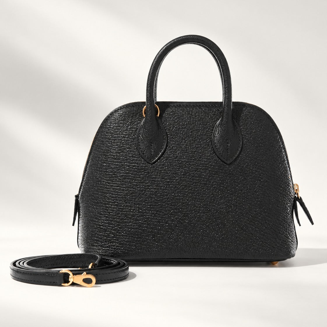Structured Mini Dome Satchel in Black vegan leather with gold-tone hardware, top handle and crossbody strap, 7.1 x 5.7 in