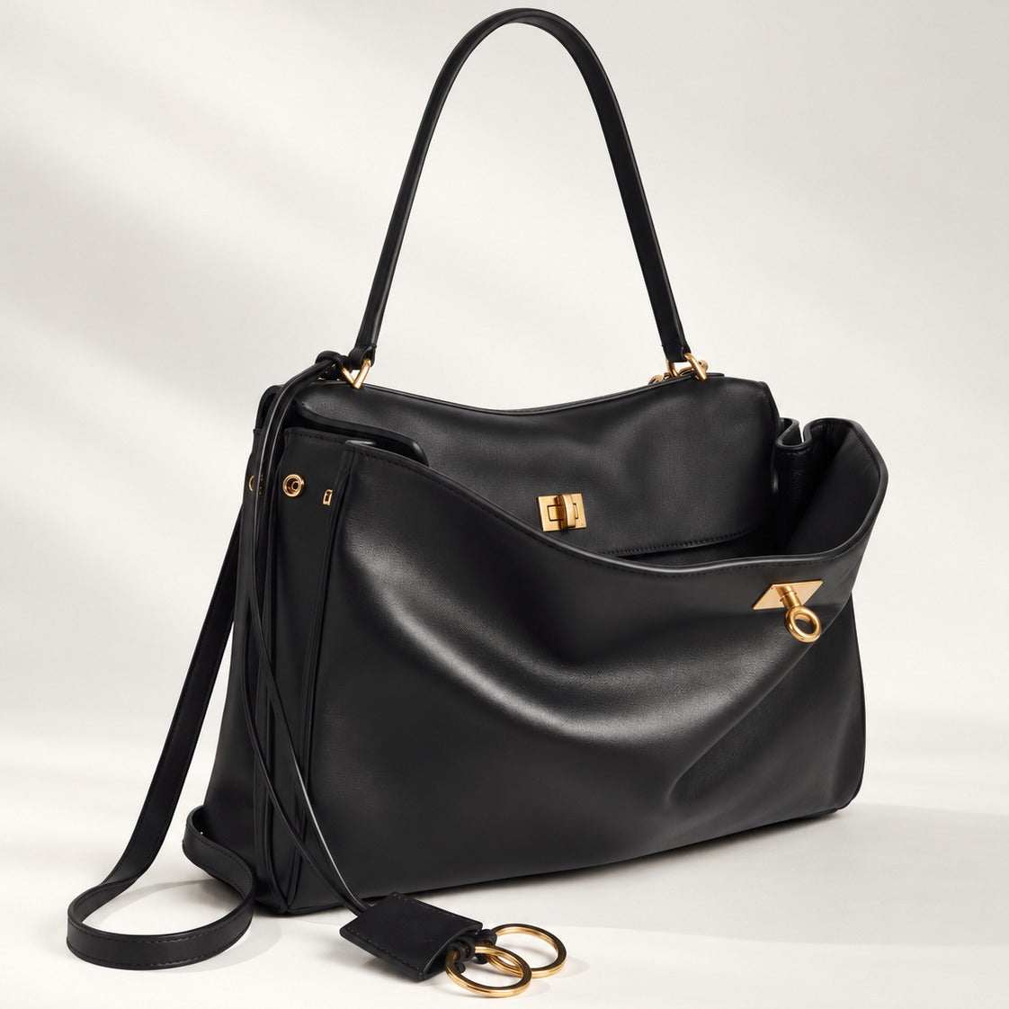 The Slouchy Medium in black vegan leather with gold hardware and turn-lock closure, relaxed medium tote, 13.8 x 9.6 in