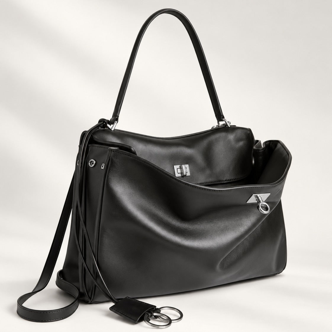 The Slouchy Medium in black vegan leather with silver hardware and turn-lock closure, relaxed medium tote, 13.8 x 9.6 in