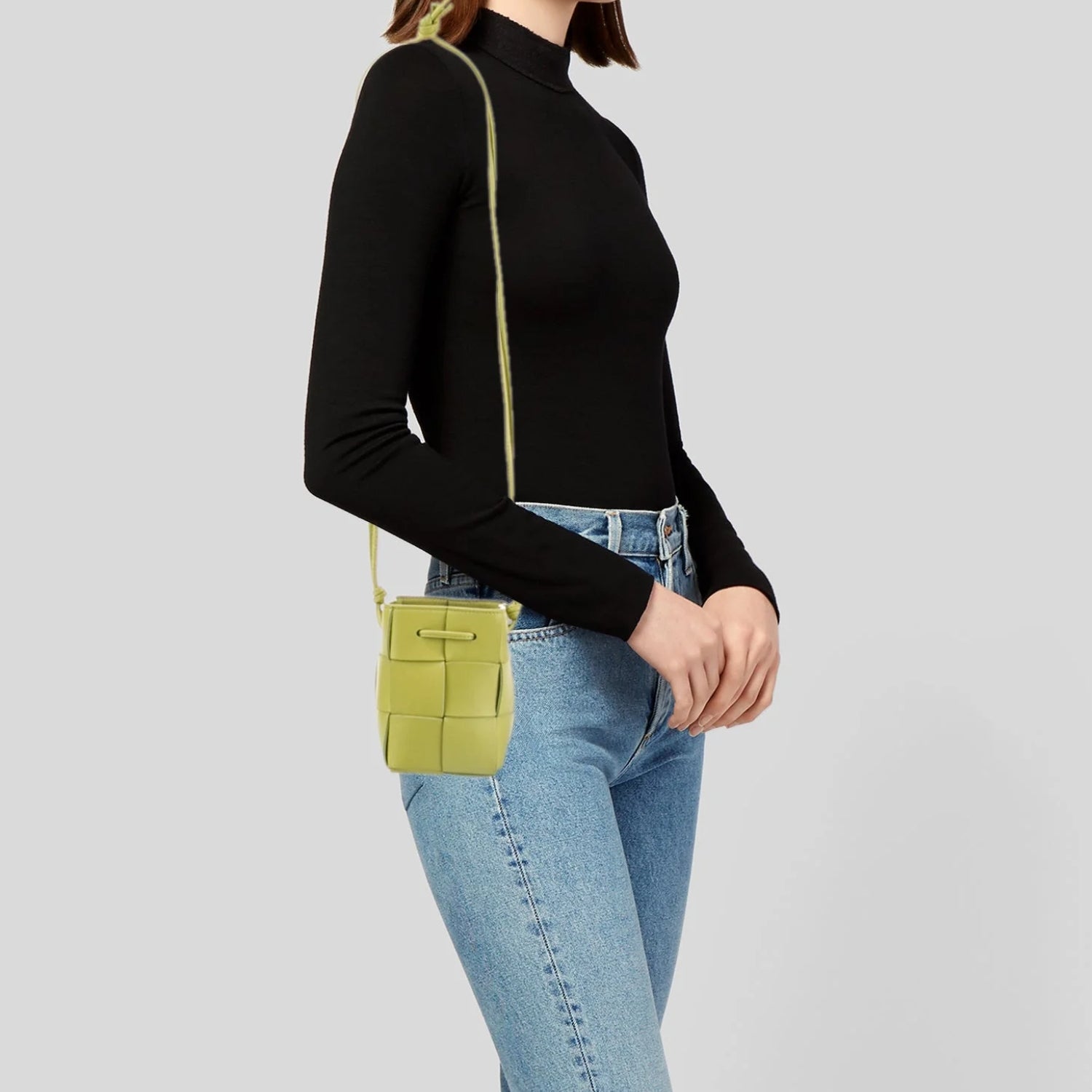 Lightweight leather woven mini bucket handbag in white with crossbody strap, kiwi gold