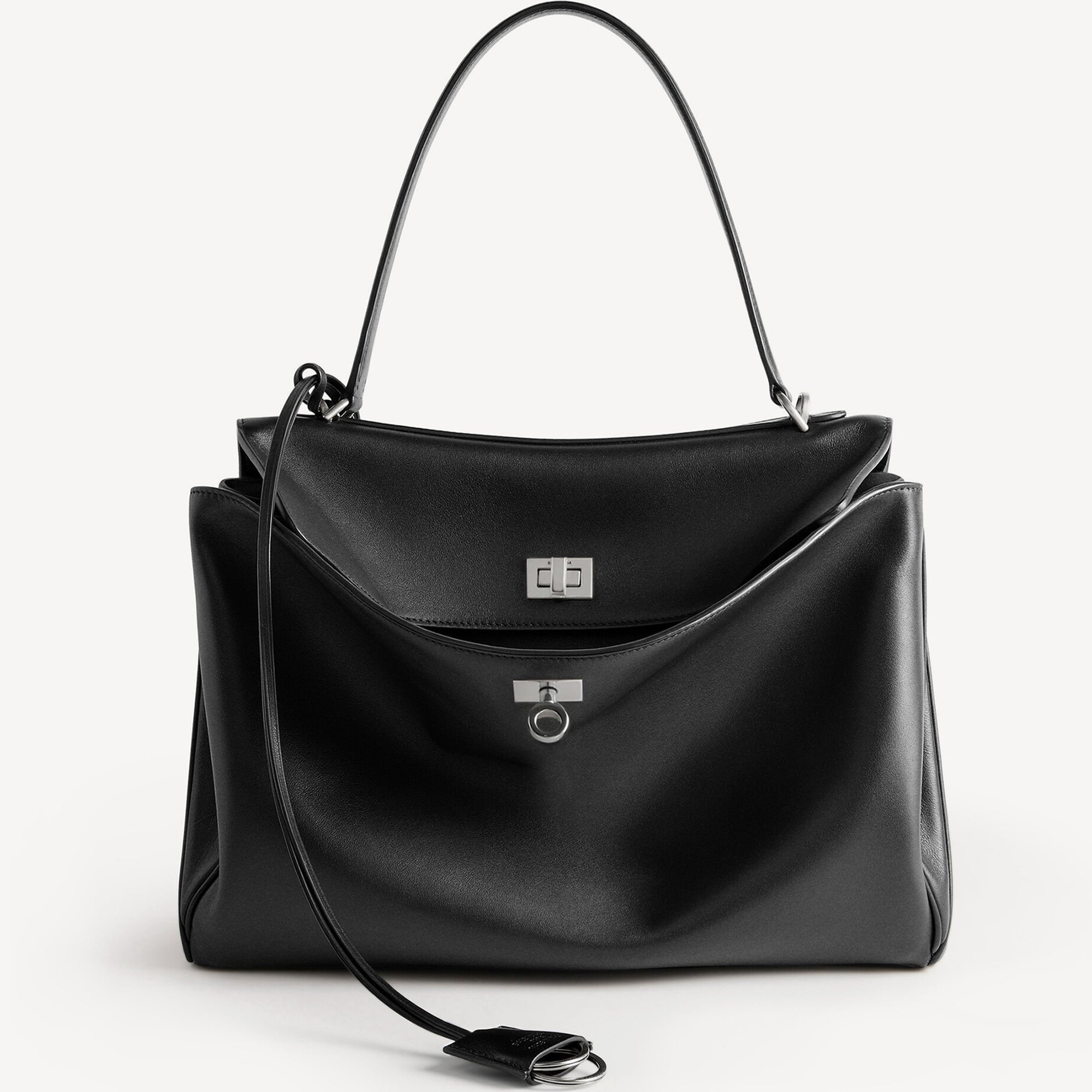 Front view of a black slouchy medium tote bag with polished silver hardware and a relaxed rectangular shape.