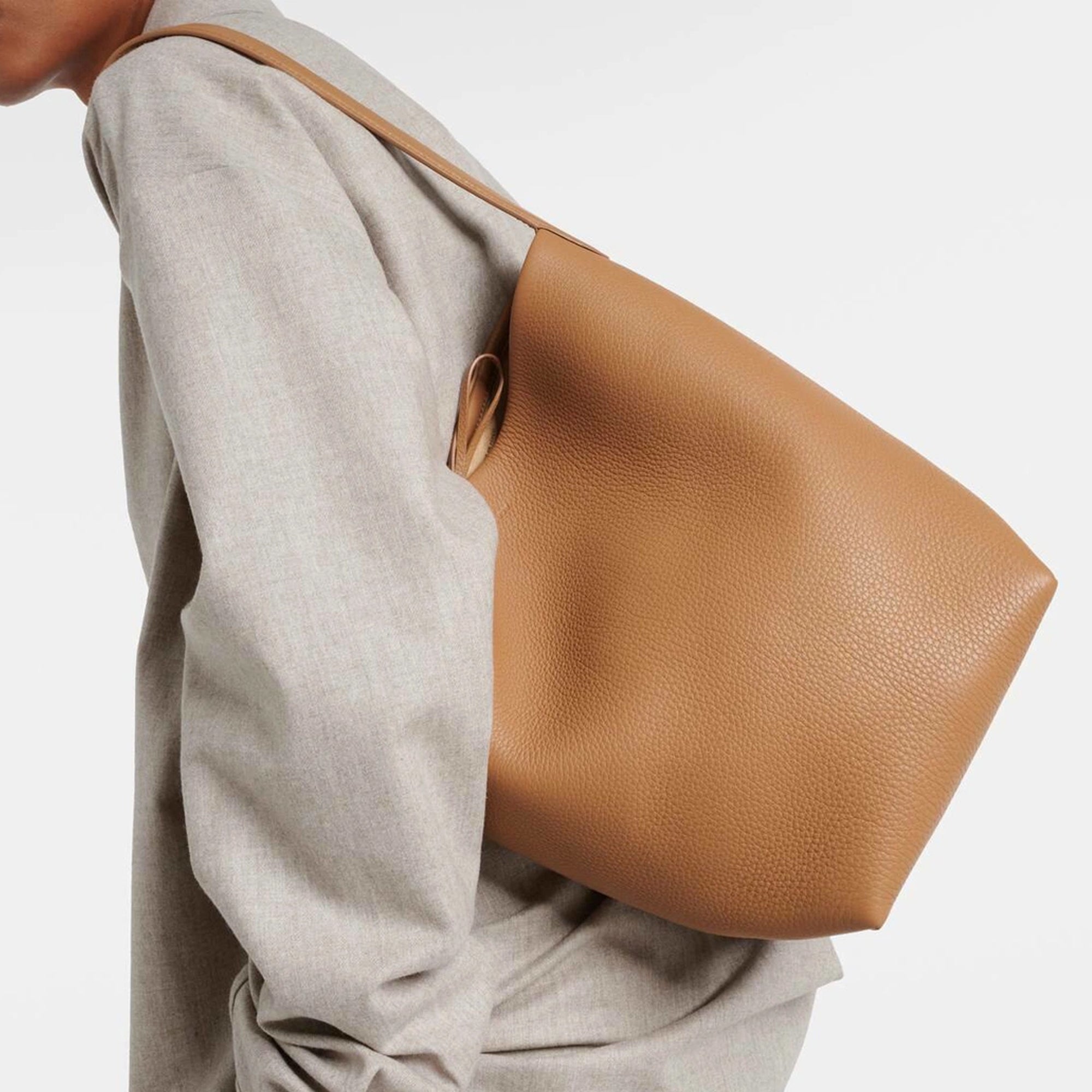 Model with camel the N/S Park style medium vertical tote in genuine leather, showcasing its clean rectangular silhouette.