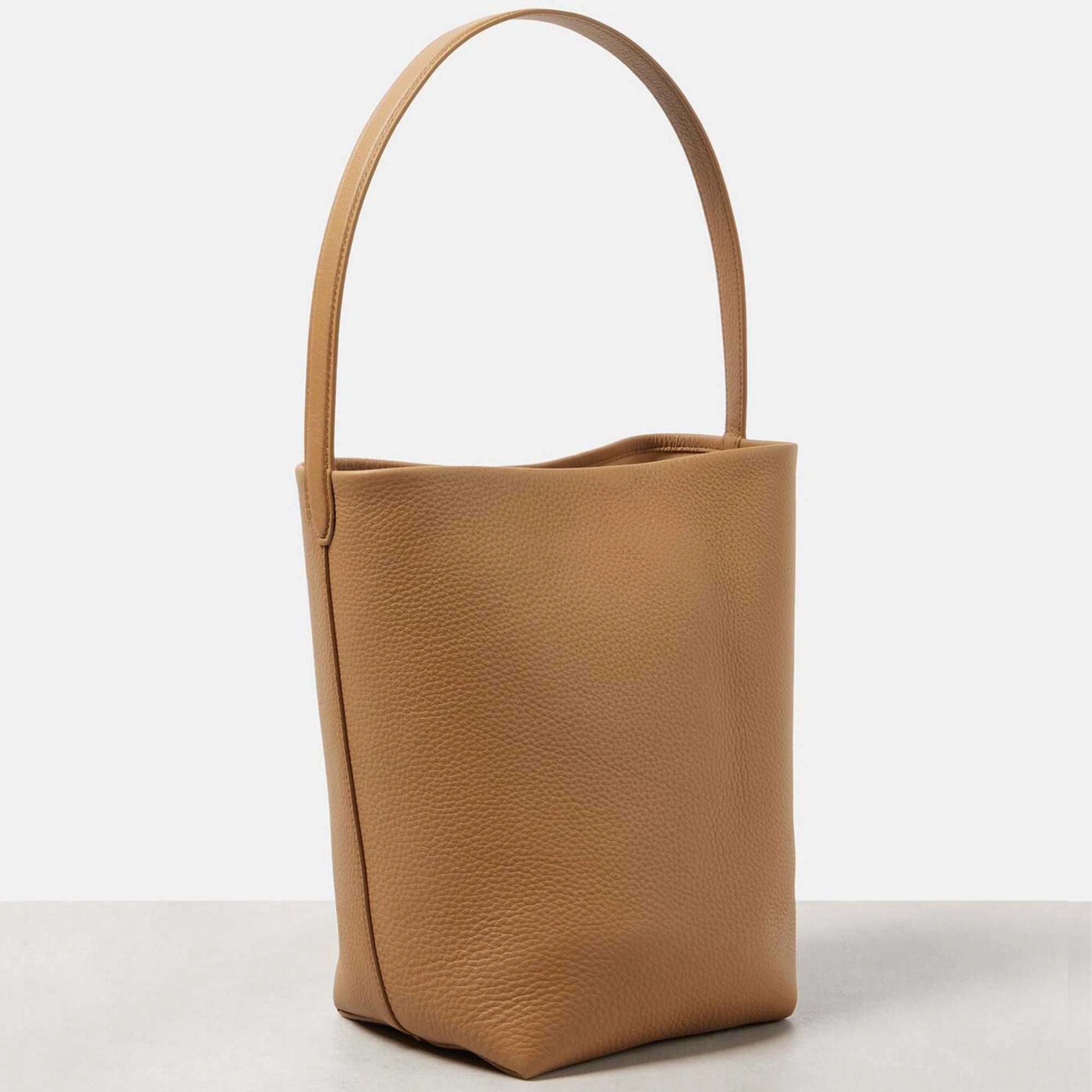 Front view of camel the N/S Park style medium vertical tote in genuine leather, showcasing its clean rectangular silhouette.