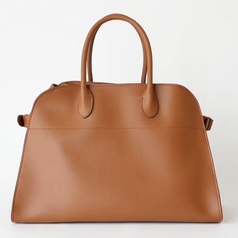 Brown structured tote bag made from premium PU, featuring a soft leather-like texture, minimal silhouette, and top handles – designed for modern, cruelty-free elegance.