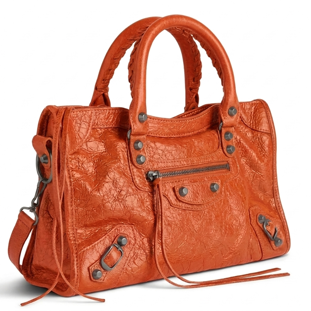 Medium city-style moto leather shoulder bag in orange with stud detailing, front view