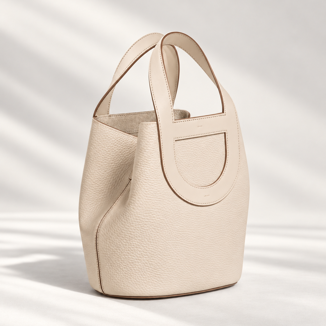 Compact Loop Leather Bucket Bag in White, smooth leather with loop handles, silver strap detail and two side pockets