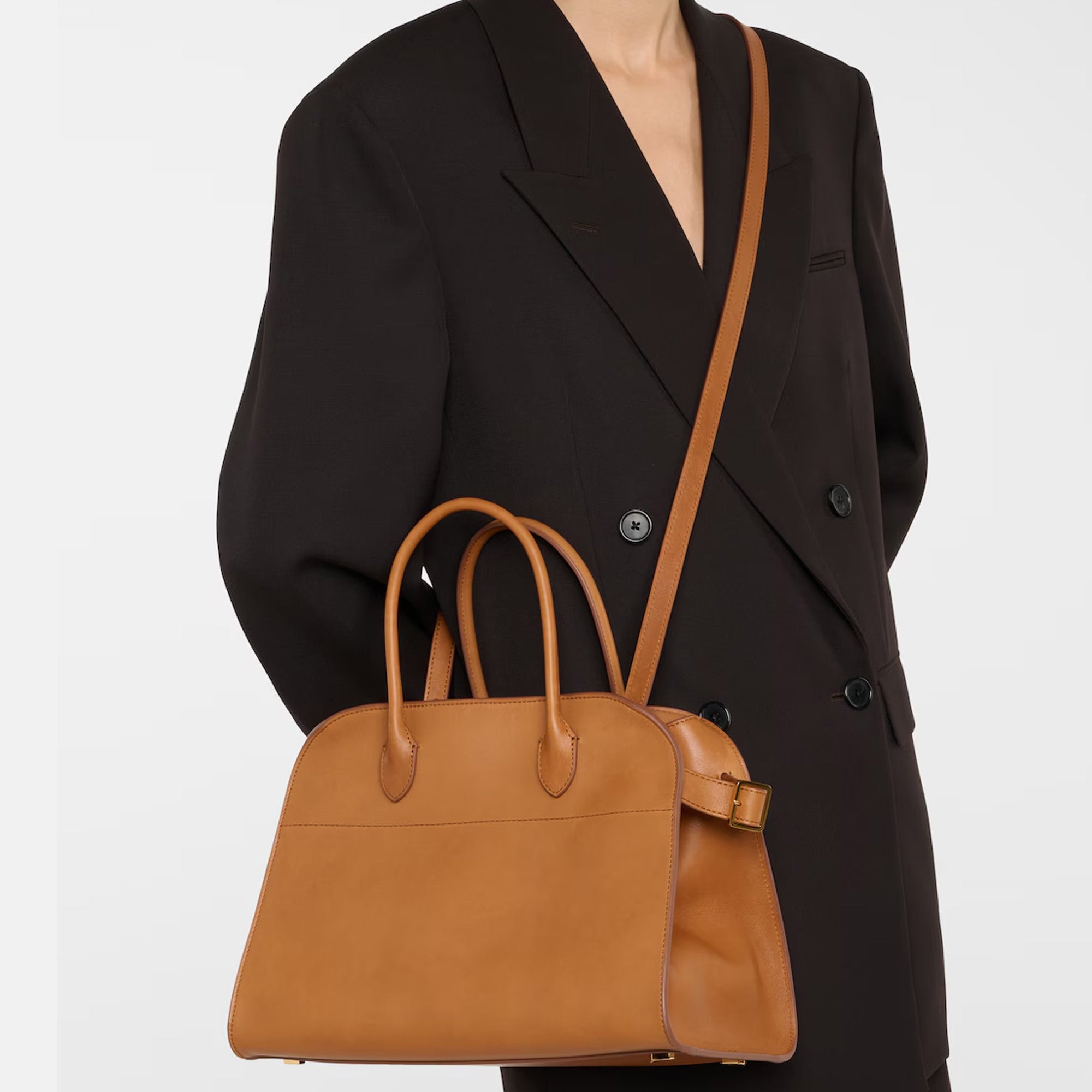 Compact brown tote bag with strap made from vegan PU leather, featuring a structured silhouette, top handles, and a modern minimal design.