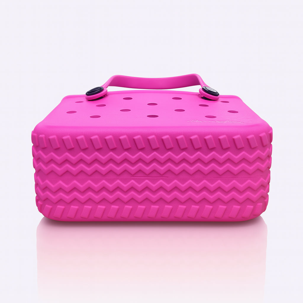Small EVA Tote in Haute Pink. Vibrant waterproof mini tote made from rubber-like EVA. Compact, stylish, and easy to carry for everyday use.