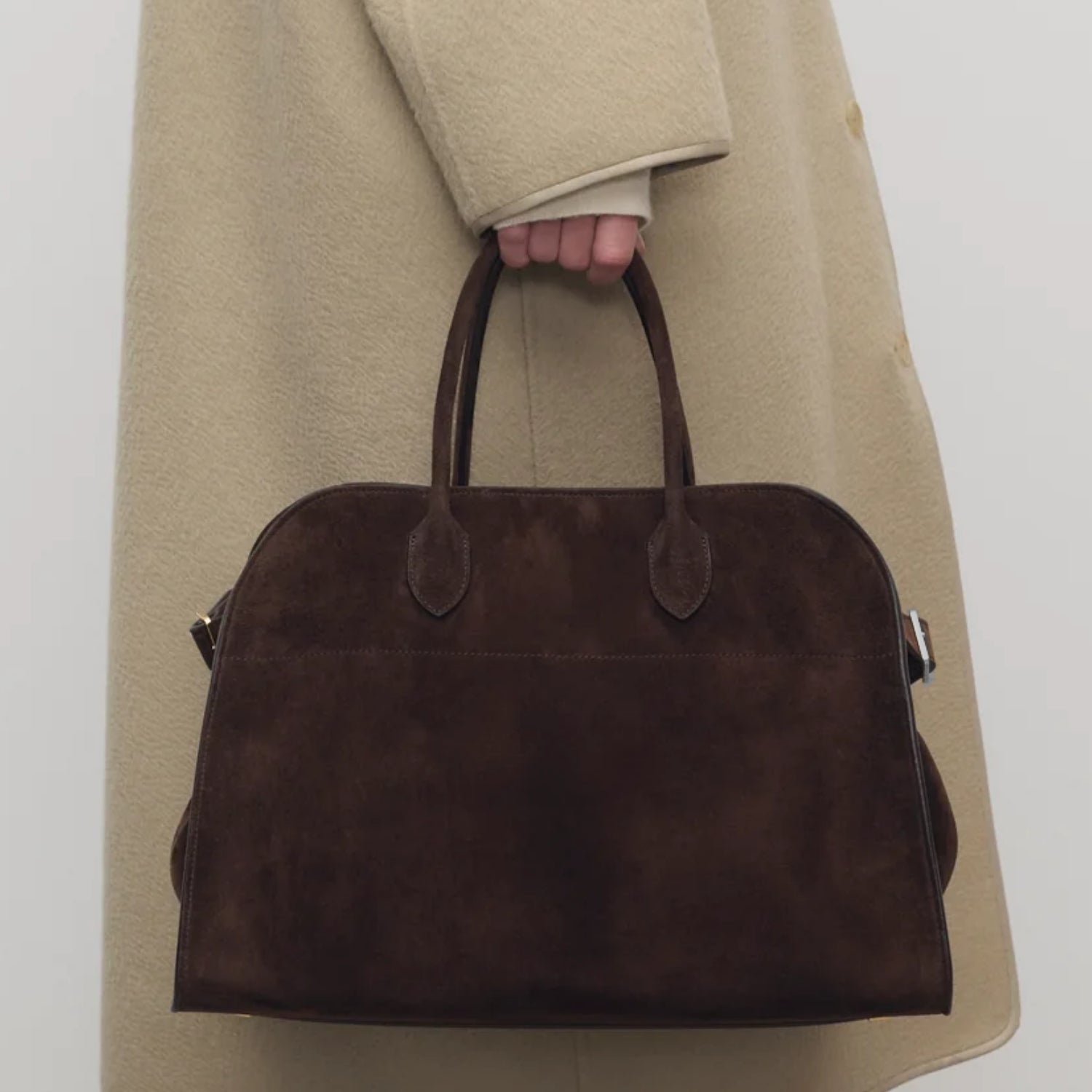model with the large Margaux 15 style suede tote in Coffee Brown with signature belted sides.