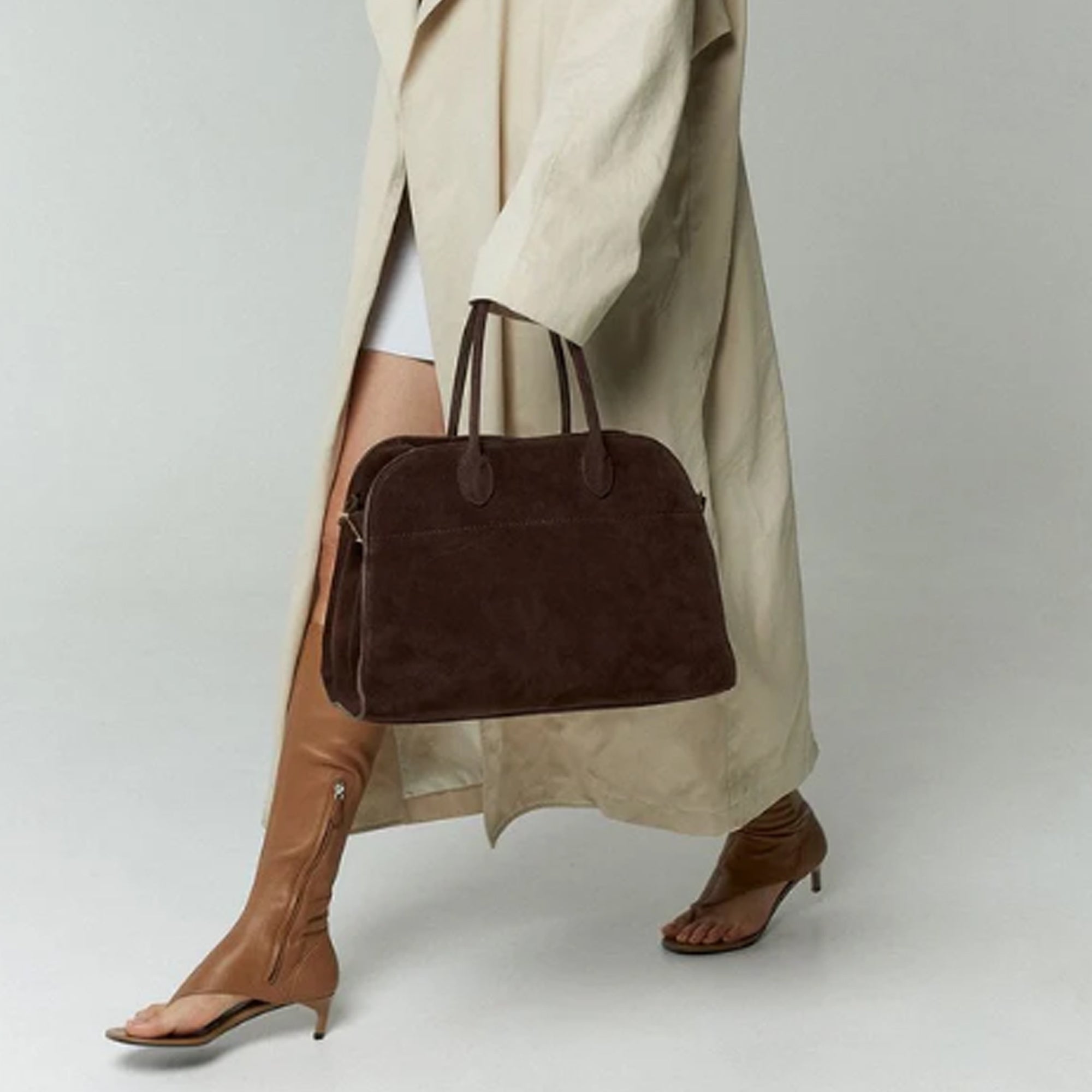 model with the large Margaux 15 style suede tote in Coffee Brown with signature belted sides.
