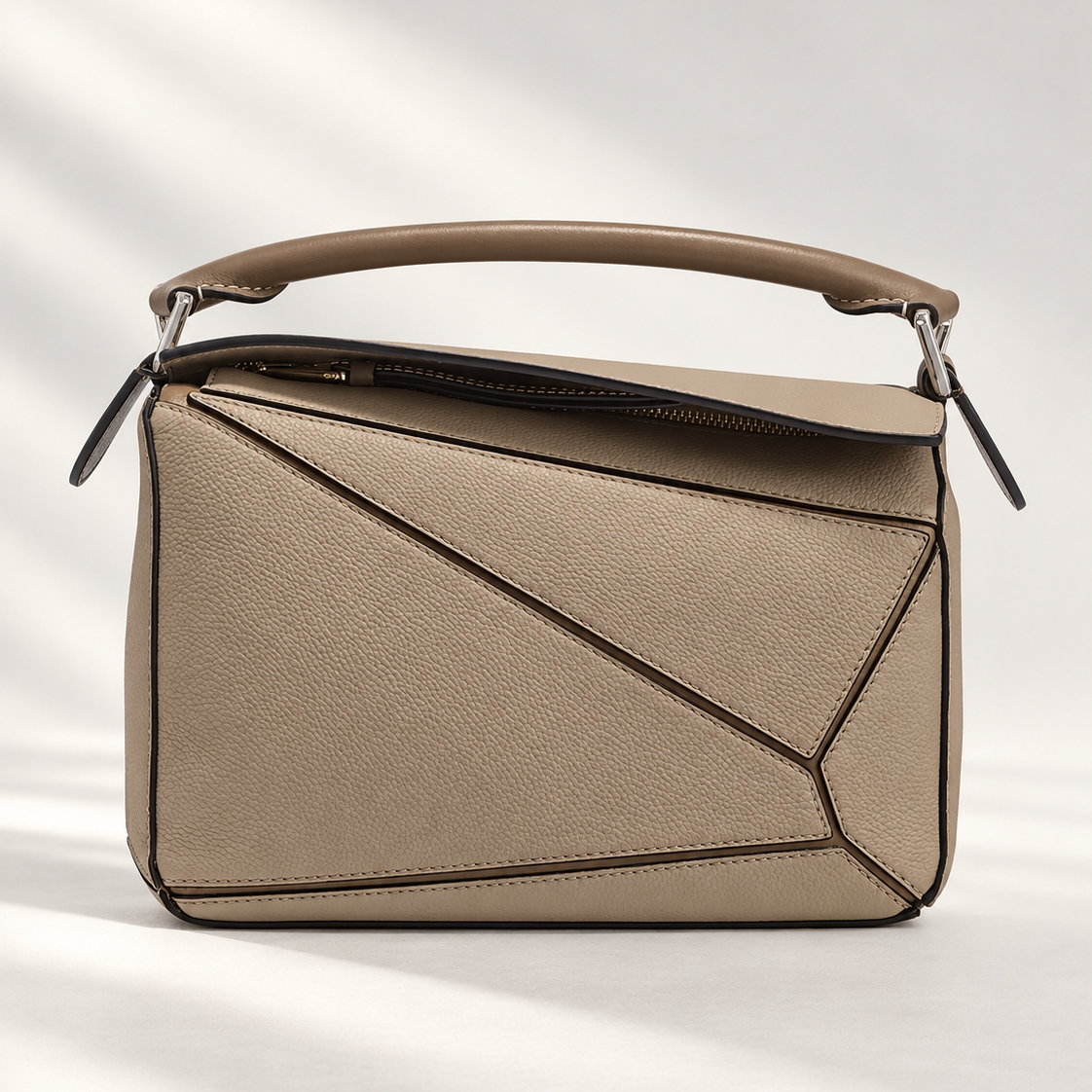 Compact Sculptural Beige Leather Bag with Silver Accents details