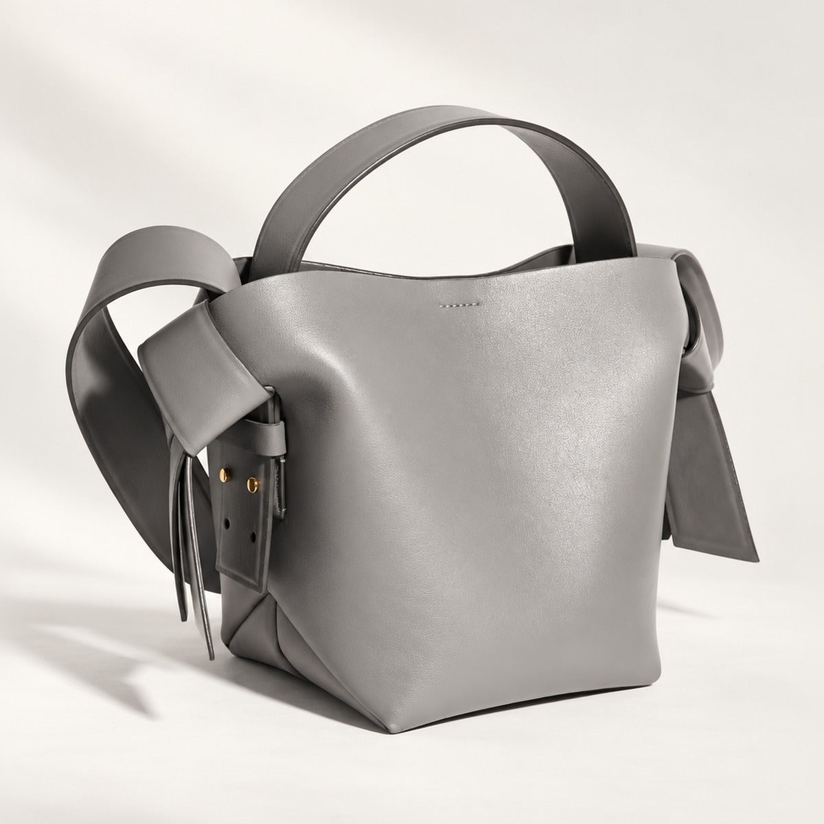 Mini Knot Leather Shoulder Bag in Gray with gold hardware, twisted knot sides, top handle and detachable crossbody strap